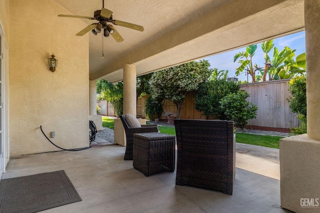 view of patio with outdoor lounge area, a ceiling fan, and a fenced backyard