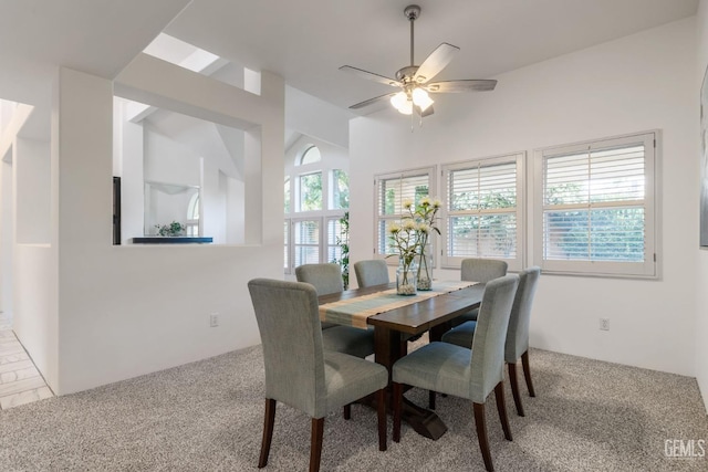carpeted dining space featuring ceiling fan