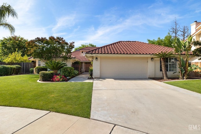 mediterranean / spanish-style house with a garage, a front lawn, fence, stucco siding, and a tiled roof