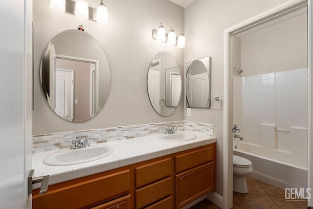 full bathroom with vanity, tile patterned floors, shower / washtub combination, toilet, and tasteful backsplash