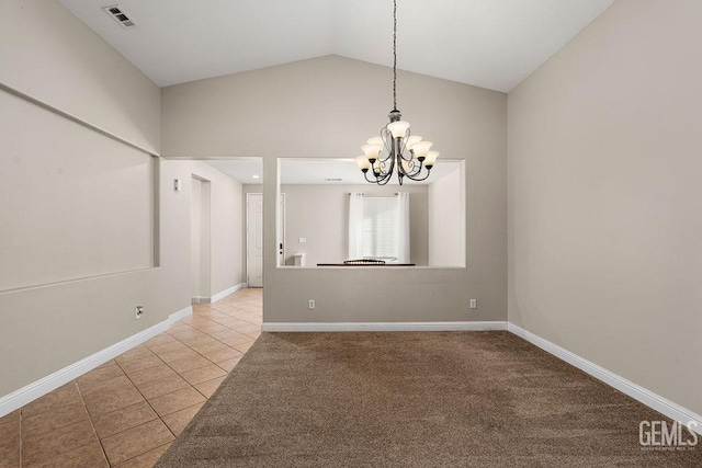 spare room with tile patterned flooring, a chandelier, and lofted ceiling