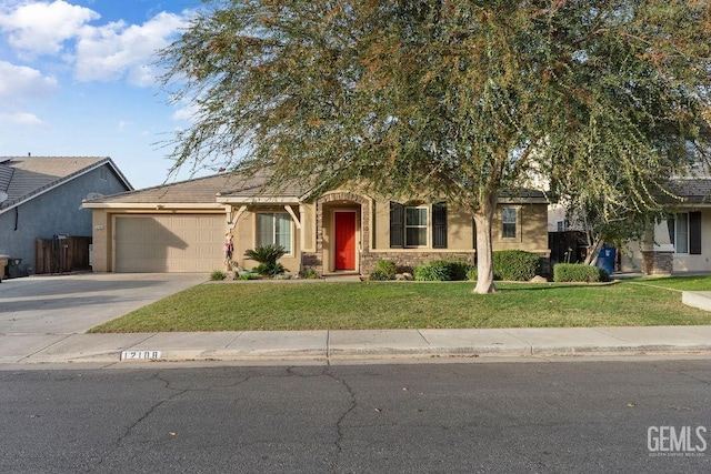 view of property hidden behind natural elements featuring a garage and a front lawn