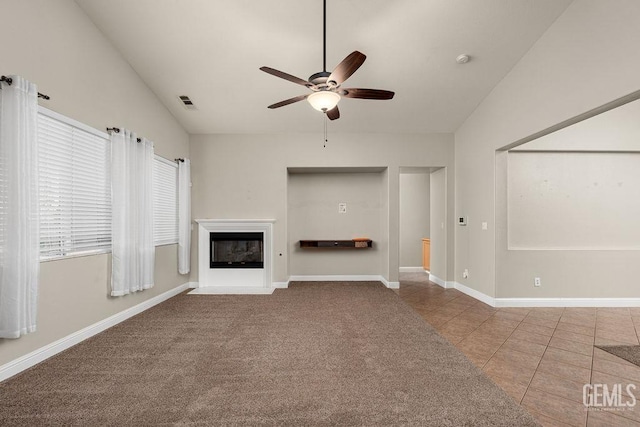 unfurnished living room with tile patterned floors, ceiling fan, and lofted ceiling