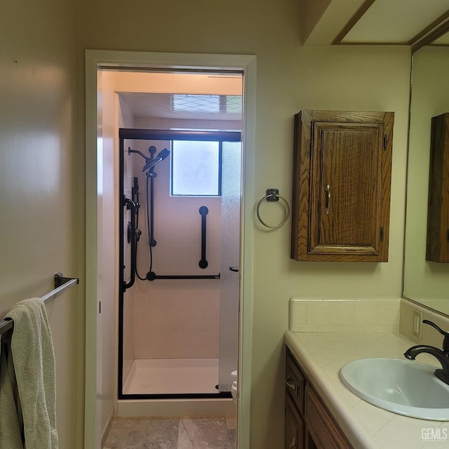 bathroom featuring vanity and a shower with door