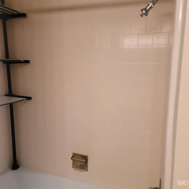 interior details with tiled shower / bath