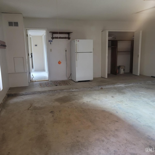 garage featuring white fridge