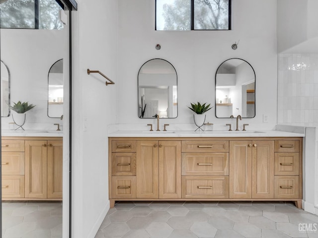 bathroom featuring a high ceiling, vanity, and tile patterned floors