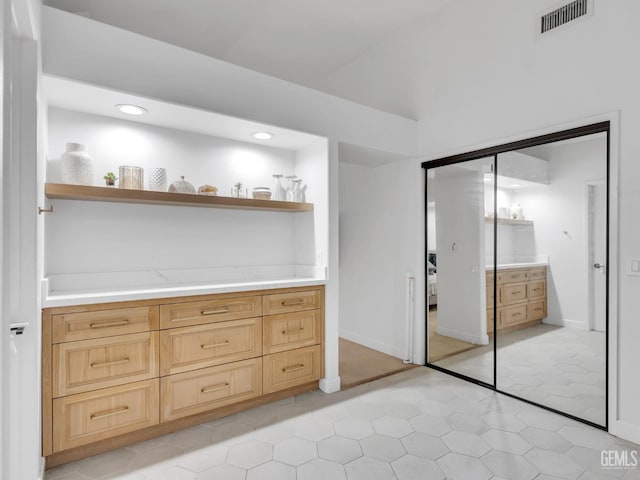 interior space featuring light brown cabinets and light tile patterned floors