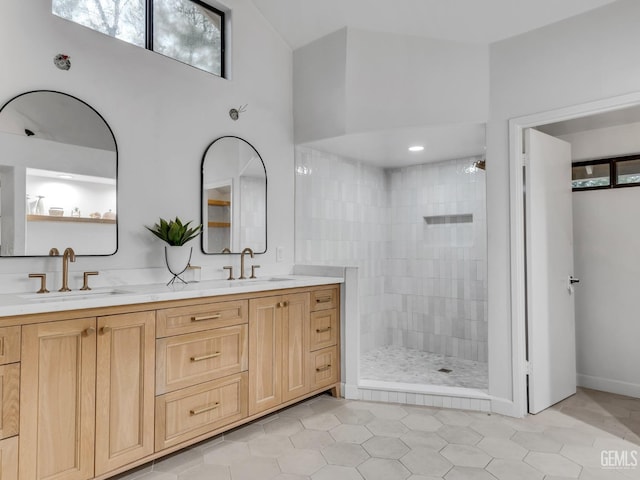 bathroom featuring tile patterned floors, vanity, and tiled shower