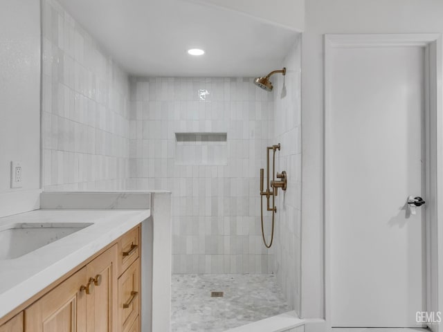 bathroom featuring vanity and a tile shower