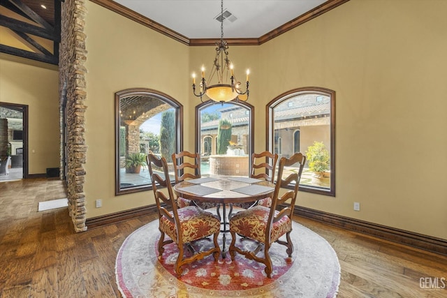 dining space featuring hardwood / wood-style flooring, crown molding, a towering ceiling, and a notable chandelier