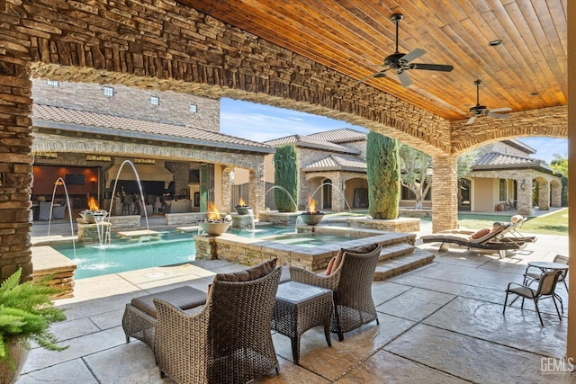 view of patio featuring pool water feature, ceiling fan, and a pool with hot tub