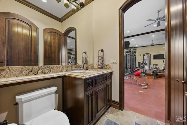 bathroom with ceiling fan, ornamental molding, and vanity