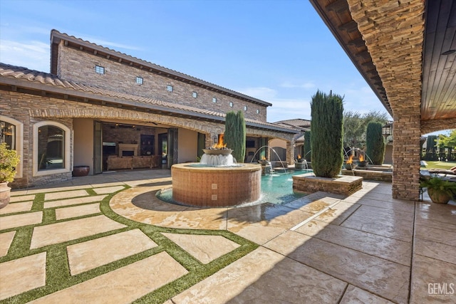 view of patio / terrace with pool water feature