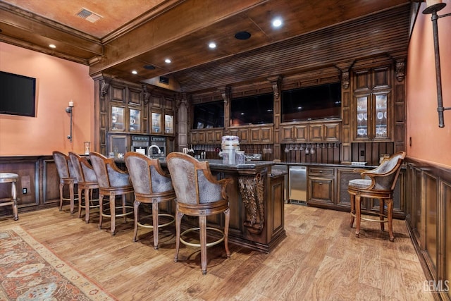 bar with wood ceiling, ornamental molding, refrigerator, and light wood-type flooring