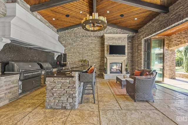 view of patio / terrace with area for grilling, exterior fireplace, grilling area, and ceiling fan