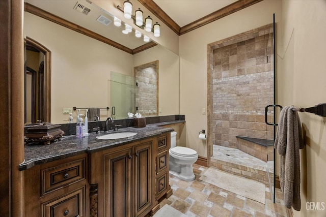 bathroom with an enclosed shower, vanity, crown molding, and toilet