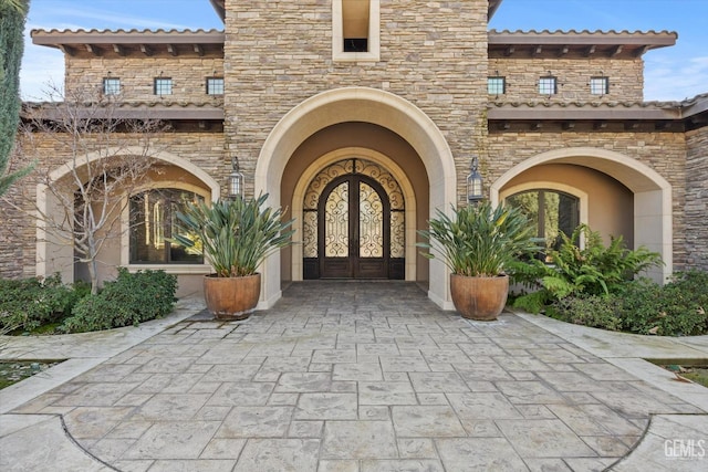 view of exterior entry featuring french doors