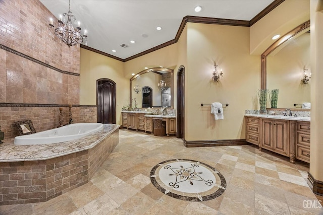 bathroom with tiled tub, vanity, and crown molding