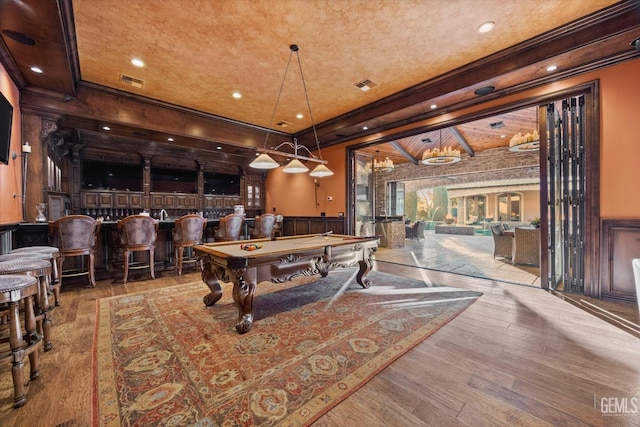 rec room featuring hardwood / wood-style flooring, ornamental molding, billiards, and indoor bar