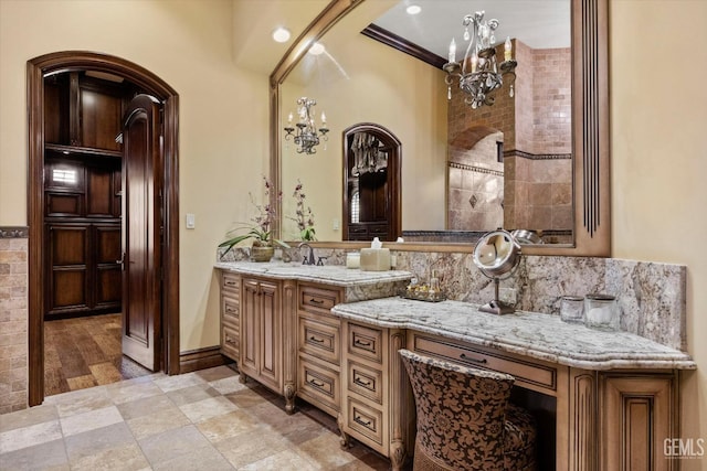 bathroom featuring vanity and a notable chandelier