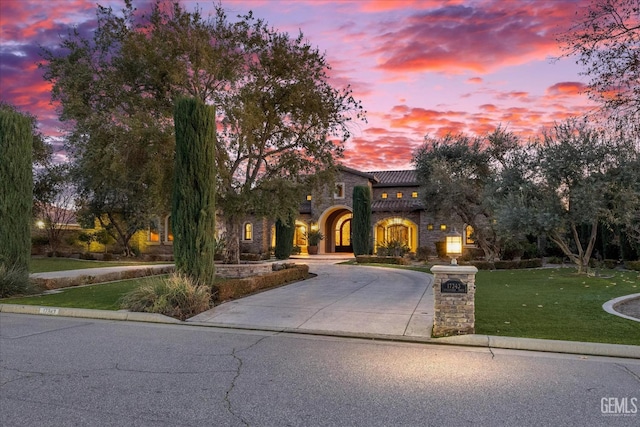 mediterranean / spanish-style house with a lawn