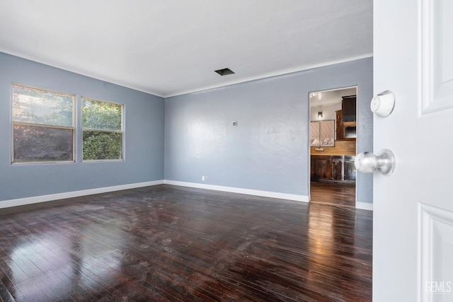 unfurnished room featuring dark hardwood / wood-style flooring