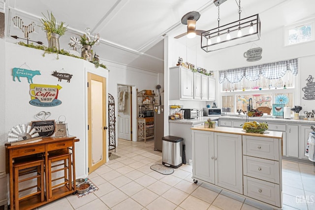 kitchen featuring white cabinetry, ceiling fan, and light tile patterned flooring