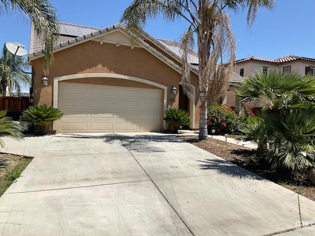 9902 Metropolitan Way, Bakersfield, CA 93311 - mediterranean / spanish house featuring stucco siding, concrete driveway, a garage, and a tile roof