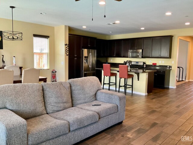 9902 Metropolitan Way, Bakersfield, CA 93311 - living room featuring wood finished floors, a ceiling fan, and recessed lighting