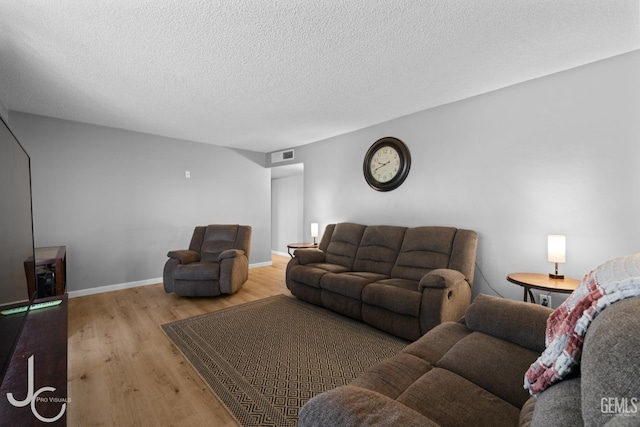 3713 Sechrest Ave, Bakersfield, CA 93309 - living room featuring wood finished floors and a textured ceiling