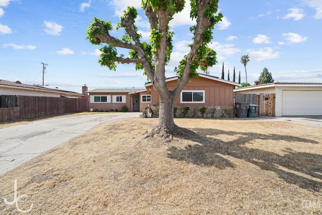 3713 Sechrest Ave, Bakersfield, CA 93309 - ranch-style house featuring board and batten siding, concrete driveway, a garage, and stone siding