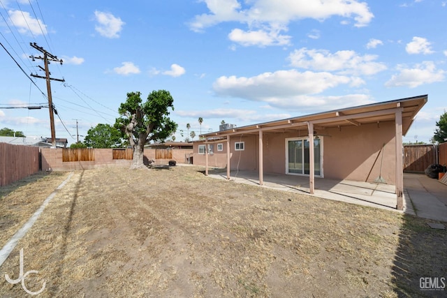 3713 Sechrest Ave, Bakersfield, CA 93309 - rear view of house with stucco siding, a patio area, and a fenced backyard
