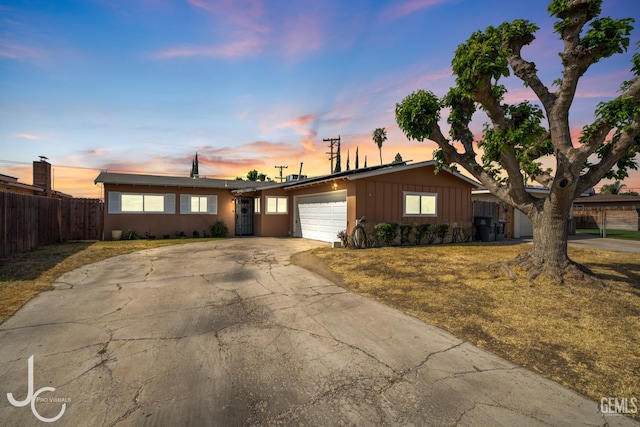 3713 Sechrest Ave, Bakersfield, CA 93309 - ranch-style home featuring a garage, board and batten siding, and driveway