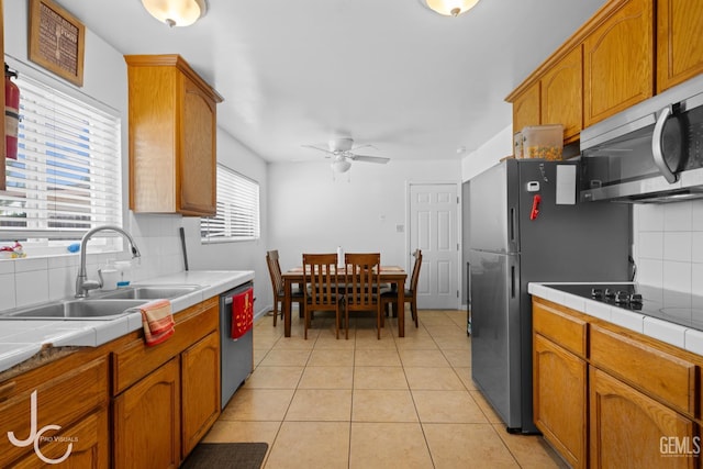 3713 Sechrest Ave, Bakersfield, CA 93309 - kitchen with tile counters, appliances with stainless steel finishes, tasteful backsplash, and ceiling fan