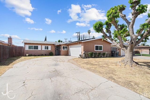 3713 Sechrest Ave, Bakersfield, CA 93309 - ranch-style house featuring an attached garage, driveway, and board and batten siding