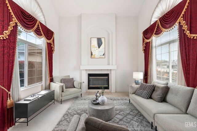 unfurnished living room with a tile fireplace and carpet flooring
