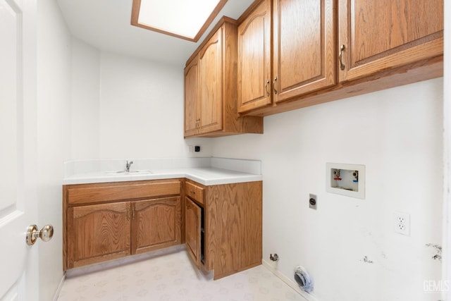 washroom featuring light floors, electric dryer hookup, cabinet space, gas dryer hookup, and washer hookup