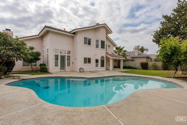 view of swimming pool with a lawn, fence, a fenced in pool, and a patio area