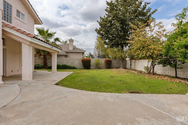 view of yard featuring a patio and a fenced backyard