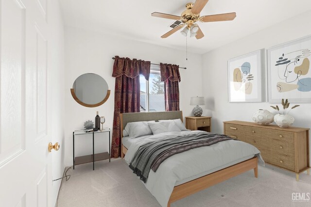 bedroom featuring light colored carpet, visible vents, and ceiling fan