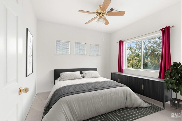 bedroom with visible vents, ceiling fan, and carpet