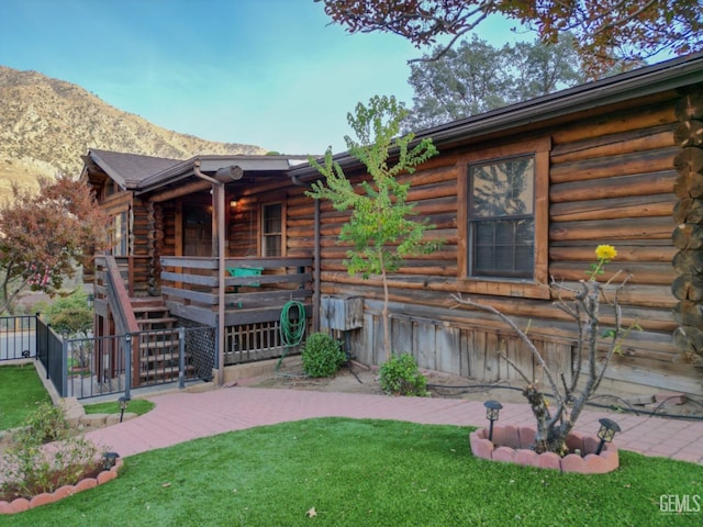 exterior space with a mountain view and a yard