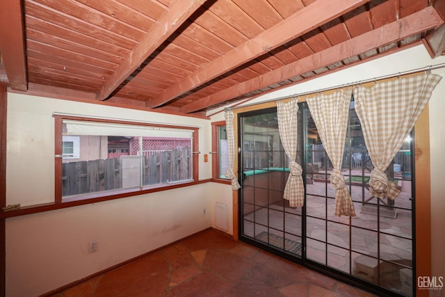 spare room with beamed ceiling and wooden ceiling