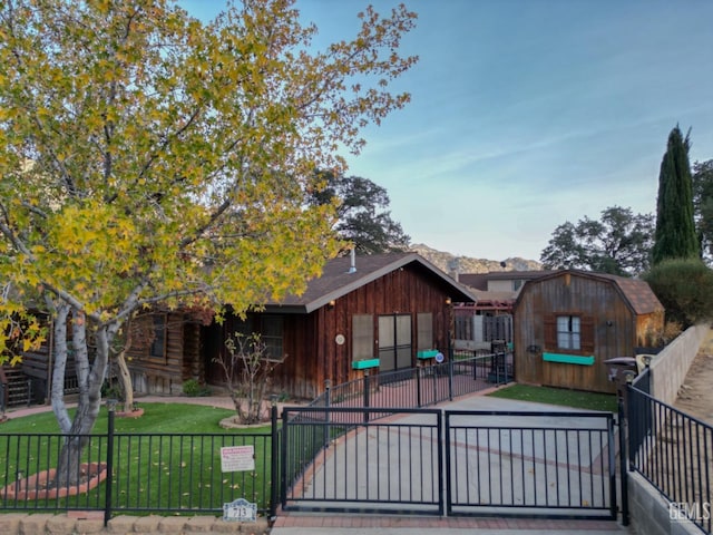 view of front facade with a front lawn and a storage unit