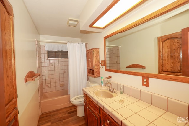 full bathroom featuring toilet, shower / tub combo with curtain, vanity, and hardwood / wood-style flooring