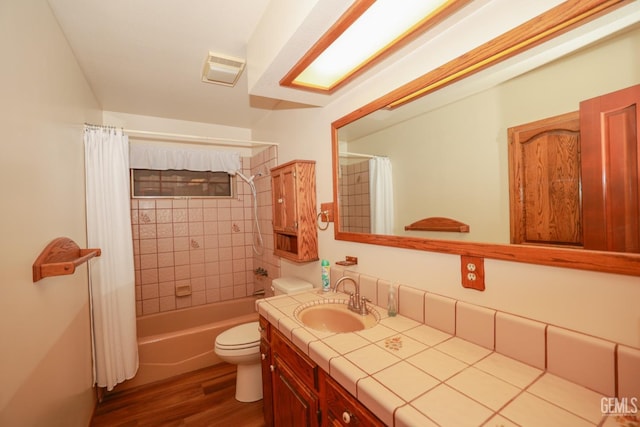 full bathroom with hardwood / wood-style flooring, vanity, toilet, and shower / bath combo with shower curtain