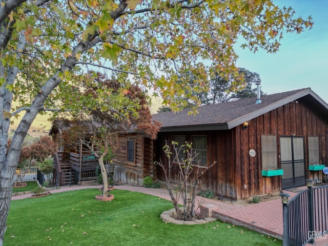 cabin with a front lawn