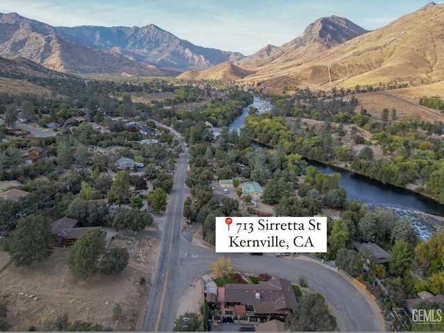 drone / aerial view with a water and mountain view