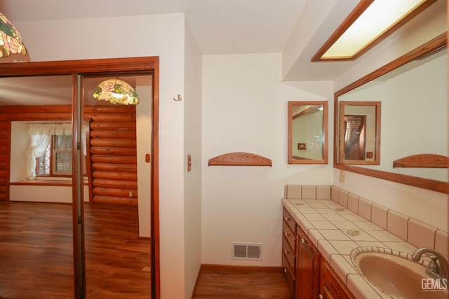 bathroom with hardwood / wood-style floors and vanity